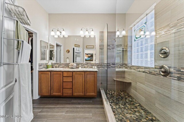 6648 Equation Dr, Sparks, NV 89436 - full bathroom with a tile shower, double vanity, and a chandelier