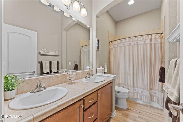 6648 Equation Dr, Sparks, NV 89436 - full bath with double vanity, wood finished floors, and a shower with shower curtain