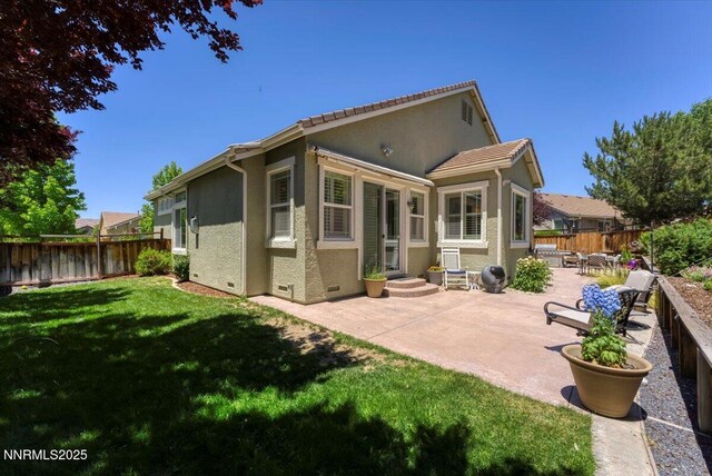 6648 Equation Dr, Sparks, NV 89436 - rear view of property featuring crawl space, stucco siding, a patio, and a fenced backyard