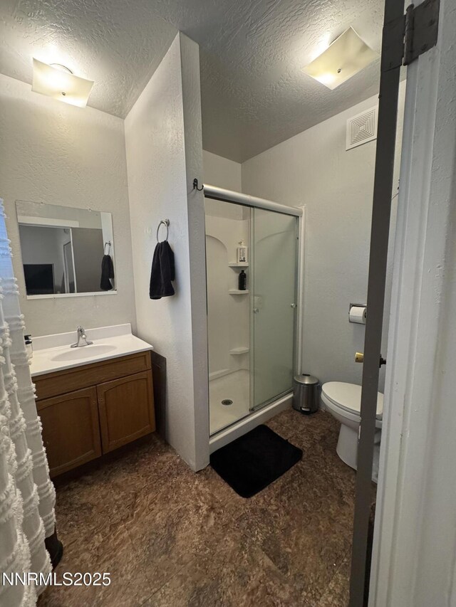 468 S Maine St, Fallon, NV 89406 - full bathroom featuring a stall shower, vanity, a textured ceiling, and tile patterned floors