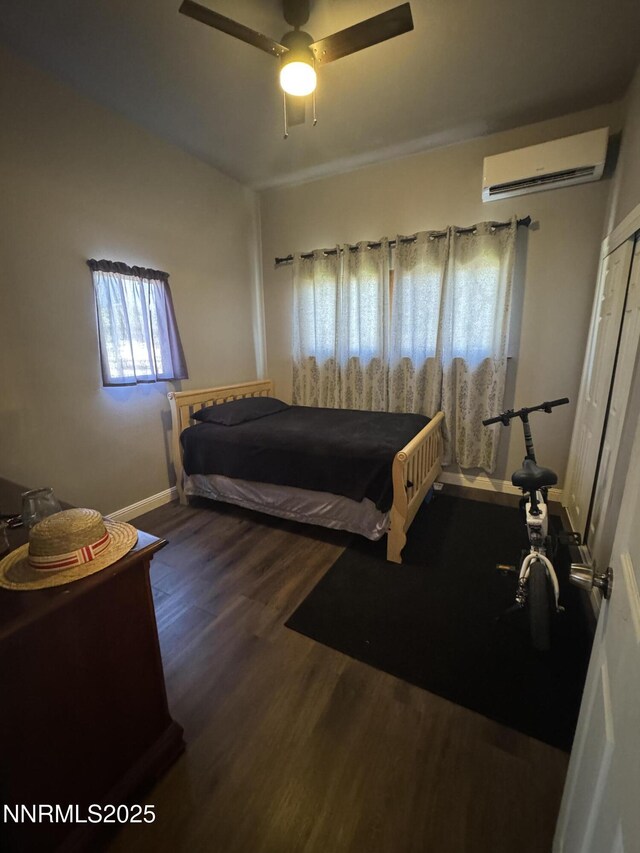 468 S Maine St, Fallon, NV 89406 - bedroom with an AC wall unit, wood finished floors, ceiling fan, and a closet