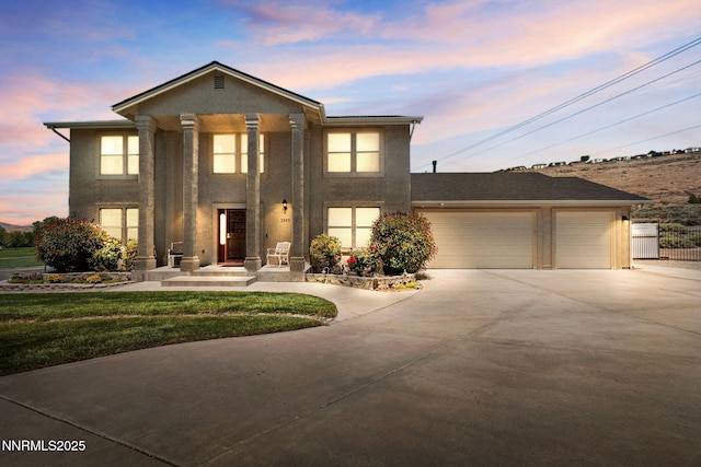 3555 Vista Blvd, Sparks, NV 89436 - neoclassical home with driveway, stucco siding, an attached garage, and a yard