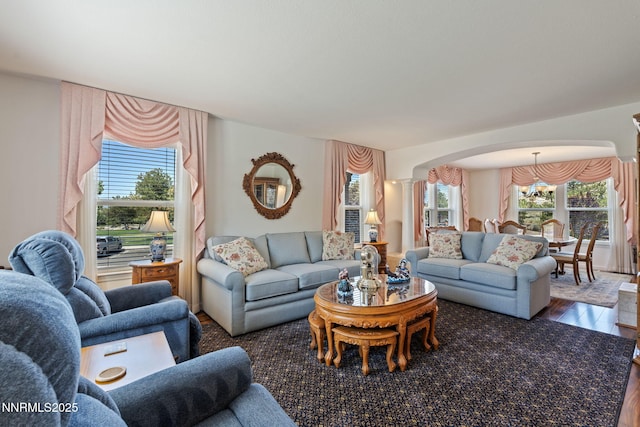 3555 Vista Blvd, Sparks, NV 89436 - living area featuring decorative columns, arched walkways, wood finished floors, and a chandelier