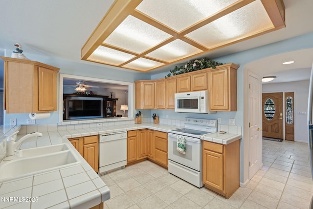 3555 Vista Blvd, Sparks, NV 89436 - kitchen with white appliances, tile countertops, ceiling fan, light tile patterned flooring, and light brown cabinetry