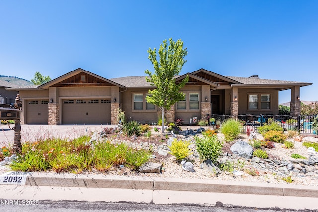 2092 Canterbury Ln, Carson City, NV 89703 - craftsman inspired home featuring stone siding, a garage, stucco siding, and driveway
