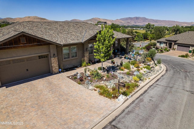 2092 Canterbury Ln, Carson City, NV 89703 - view of front facade with a mountain view, decorative driveway, a garage, stucco siding, and a shingled roof