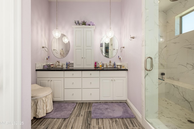 2092 Canterbury Ln, Carson City, NV 89703 - bathroom featuring a marble finish shower, wood finish floors, and double vanity