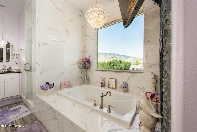 2092 Canterbury Ln, Carson City, NV 89703 - bathroom featuring vanity, a marble finish shower, a bath, and a chandelier