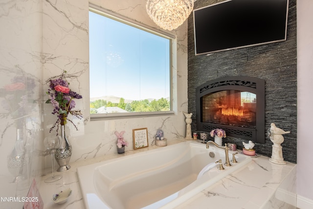 2092 Canterbury Ln, Carson City, NV 89703 - full bath featuring a garden tub, a glass covered fireplace, a chandelier, and marble finish floors