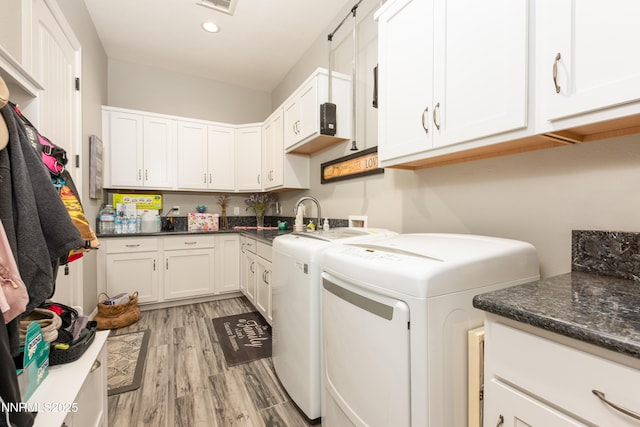 2092 Canterbury Ln, Carson City, NV 89703 - washroom featuring separate washer and dryer, cabinet space, light wood-style flooring, and recessed lighting