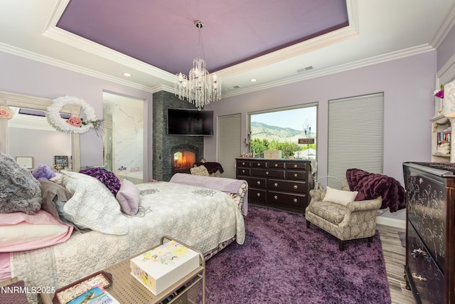 2092 Canterbury Ln, Carson City, NV 89703 - bedroom with a tray ceiling, a chandelier, crown molding, a fireplace, and wood finished floors