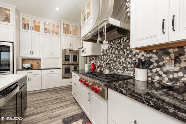 2092 Canterbury Ln, Carson City, NV 89703 - kitchen featuring appliances with stainless steel finishes, white cabinets, tasteful backsplash, recessed lighting, and range hood