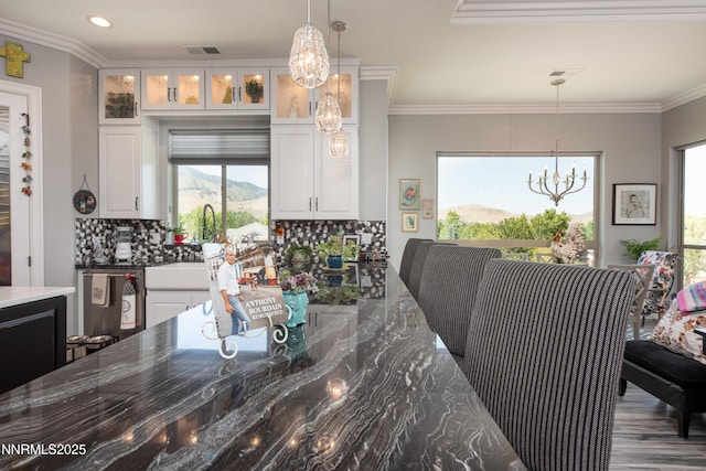 2092 Canterbury Ln, Carson City, NV 89703 - dining room featuring a chandelier, plenty of natural light, a mountain view, crown molding, and recessed lighting