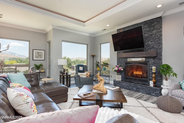 2092 Canterbury Ln, Carson City, NV 89703 - living room featuring wood finished floors, a stone fireplace, crown molding, a mountain view, and recessed lighting
