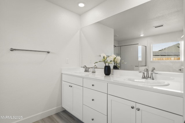 6496 Arc Dome Dr, Carson City, NV 89701 - full bath featuring double vanity, wood finished floors, and a shower