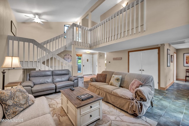 6437 Meadow Valley Ln, Reno, NV 89519 - living room with a ceiling fan, a towering ceiling, and stairway