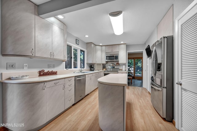 6437 Meadow Valley Ln, Reno, NV 89519 - kitchen with appliances with stainless steel finishes, a kitchen island, light wood-type flooring, light countertops, and recessed lighting
