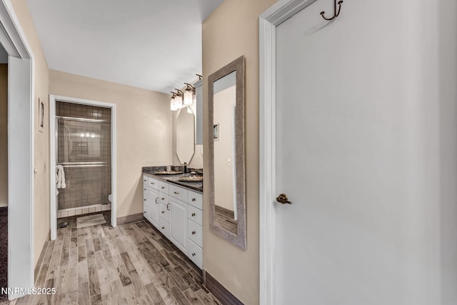 6437 Meadow Valley Ln, Reno, NV 89519 - bathroom featuring vanity, a shower stall, and wood finished floors