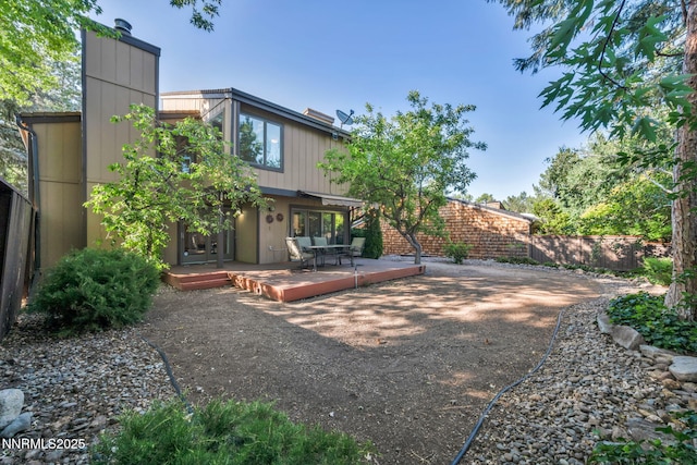 6437 Meadow Valley Ln, Reno, NV 89519 - rear view of house with a chimney and a wooden deck
