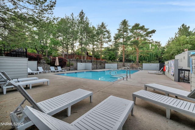 6437 Meadow Valley Ln, Reno, NV 89519 - community pool featuring a patio area and view of wooded area