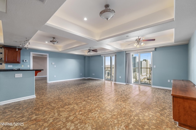 200 W 2nd St Apt 1501, Reno, NV 89501 - unfurnished living room featuring a ceiling fan and a tray ceiling
