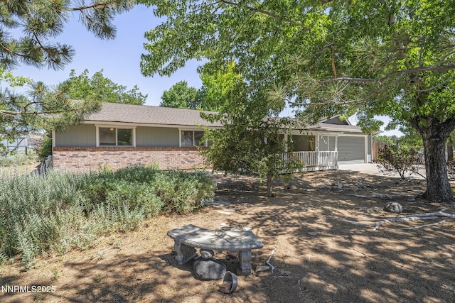 9100 Rain Dance Way, Reno, NV 89506 - view of front facade featuring brick siding, a garage, and driveway