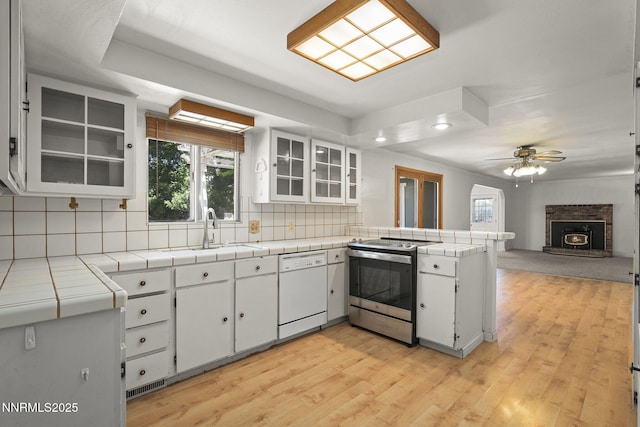 9100 Rain Dance Way, Reno, NV 89506 - kitchen with stainless steel range with electric stovetop, white dishwasher, a peninsula, white cabinetry, and tile countertops