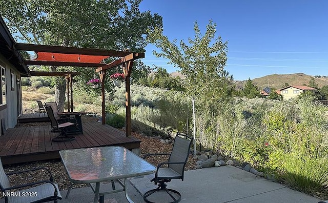 80 Bobcat Dr, Reno, NV 89523 - view of patio / terrace with a deck with mountain view, outdoor dining space, and a pergola