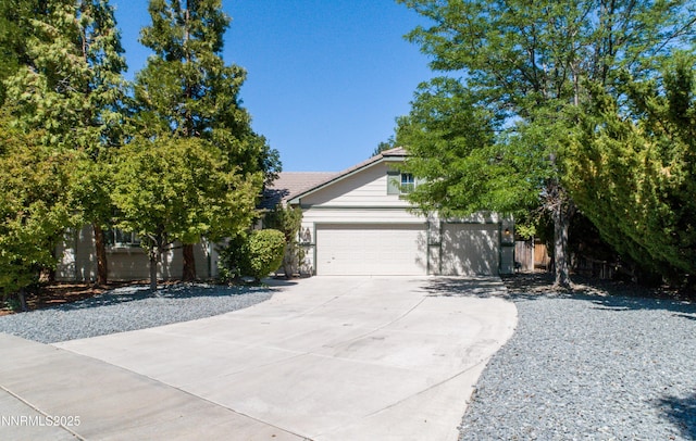 6993 Cinnamon Dr, Sparks, NV 89436 - view of property hidden behind natural elements featuring concrete driveway, a tile roof, and a garage