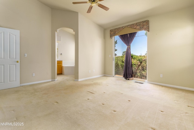 6993 Cinnamon Dr, Sparks, NV 89436 - empty room with arched walkways, a ceiling fan, carpet flooring, and high vaulted ceiling