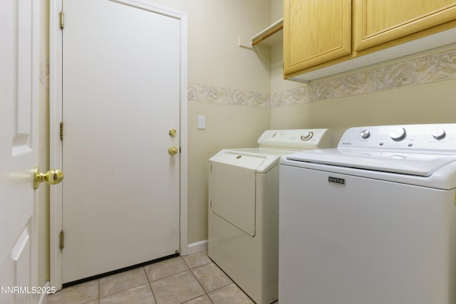 6993 Cinnamon Dr, Sparks, NV 89436 - laundry area featuring cabinet space, washer and clothes dryer, and light tile patterned floors