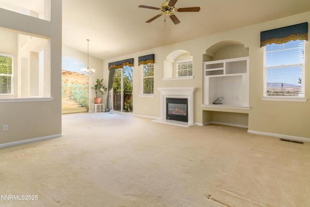 6993 Cinnamon Dr, Sparks, NV 89436 - unfurnished living room featuring a glass covered fireplace, plenty of natural light, carpet floors, and vaulted ceiling