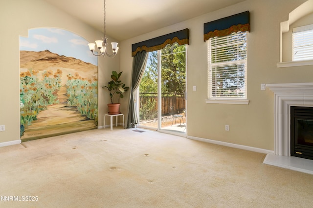 6993 Cinnamon Dr, Sparks, NV 89436 - unfurnished dining area featuring plenty of natural light, carpet, a glass covered fireplace, a chandelier, and vaulted ceiling