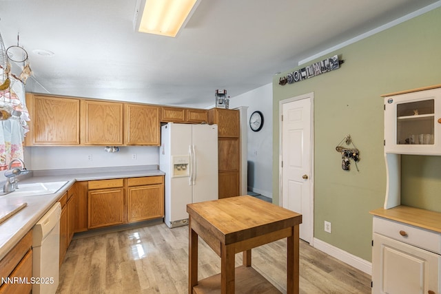 5886 Wishbone Ct, Sun Valley, NV 89433 - kitchen with white appliances, light wood finished floors, and light countertops
