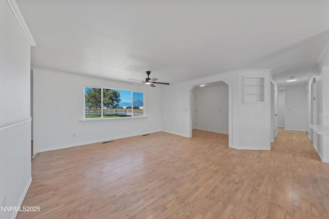 1314 Johnson Ln, Minden, NV 89423 - unfurnished living room with a ceiling fan, light wood-type flooring, and arched walkways