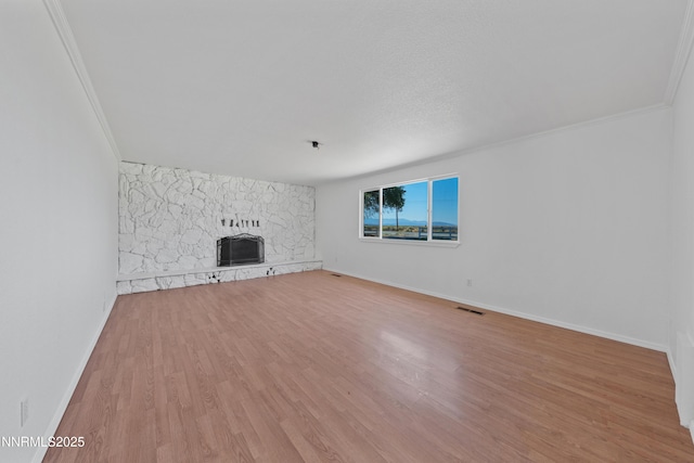 1314 Johnson Ln, Minden, NV 89423 - unfurnished living room featuring wood finished floors, a stone fireplace, and crown molding