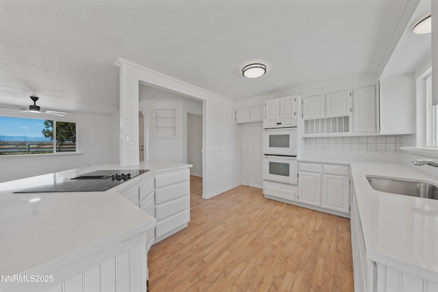 1314 Johnson Ln, Minden, NV 89423 - kitchen featuring white double oven, black electric cooktop, light countertops, and light wood finished floors