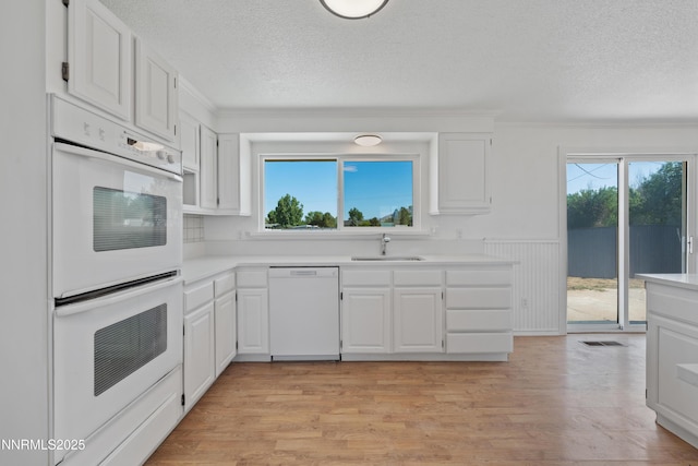 1314 Johnson Ln, Minden, NV 89423 - kitchen with white appliances, a textured ceiling, plenty of natural light, crown molding, and white cabinetry