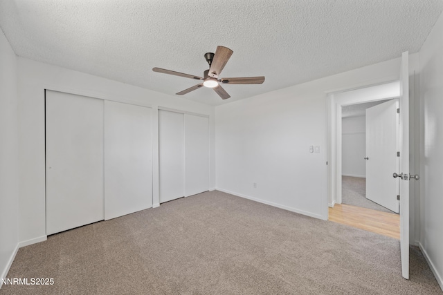 1314 Johnson Ln, Minden, NV 89423 - unfurnished bedroom featuring carpet flooring, a textured ceiling, multiple closets, and a ceiling fan