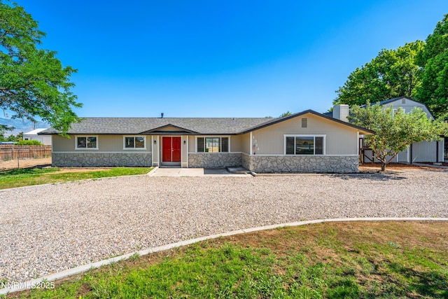 1314 Johnson Ln, Minden, NV 89423 - single story home featuring stone siding, a storage shed, and a chimney