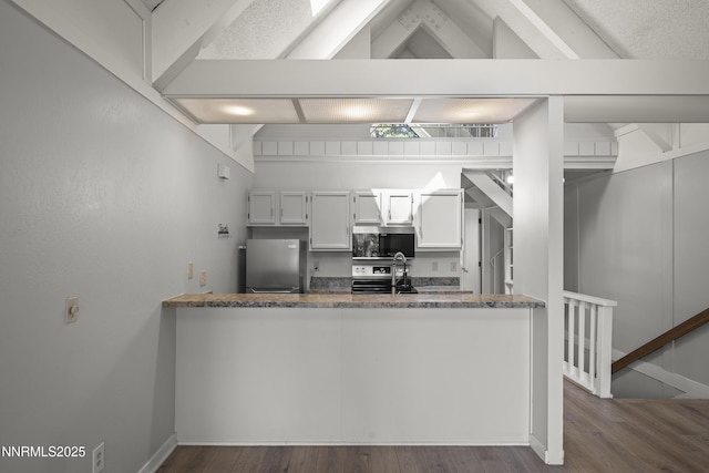 989 Tahoe Blvd Unit 71, Incline Village, NV 89451 - kitchen with appliances with stainless steel finishes, dark wood-type flooring, a peninsula, white cabinets, and beam ceiling