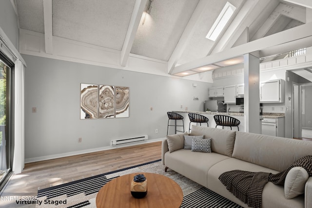 989 Tahoe Blvd Unit 71, Incline Village, NV 89451 - living area featuring a baseboard radiator, light wood-style flooring, beamed ceiling, high vaulted ceiling, and a textured ceiling