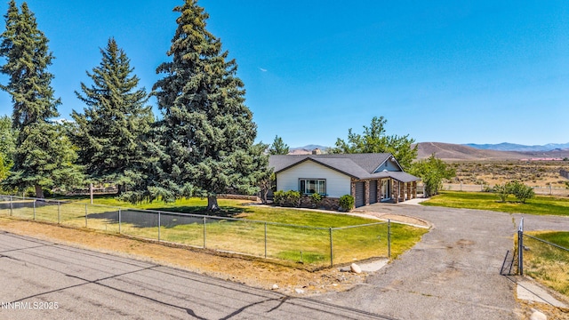1513 S Riverview Dr, Gardnerville, NV 89460 - ranch-style house with a fenced front yard, driveway, a mountain view, and an attached garage