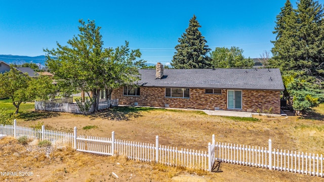 1513 S Riverview Dr, Gardnerville, NV 89460 - single story home with brick siding, a chimney, a patio, and a shingled roof