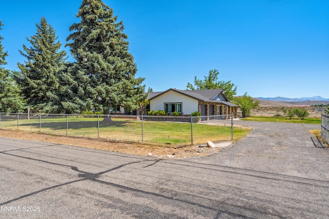 1513 S Riverview Dr, Gardnerville, NV 89460 - view of front of home featuring a fenced front yard, asphalt driveway, and a mountain view