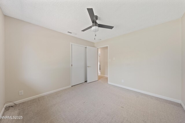 1513 S Riverview Dr, Gardnerville, NV 89460 - unfurnished bedroom featuring light carpet, a textured ceiling, a closet, and a ceiling fan