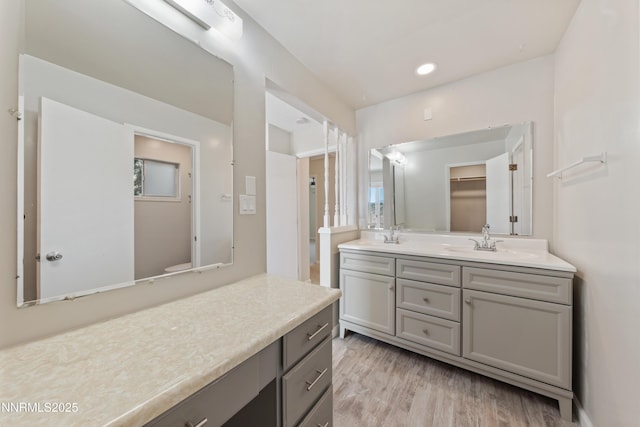 1513 S Riverview Dr, Gardnerville, NV 89460 - full bathroom featuring double vanity, wood finished floors, and recessed lighting