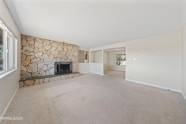 1513 S Riverview Dr, Gardnerville, NV 89460 - unfurnished living room with a textured ceiling, carpet, and a stone fireplace