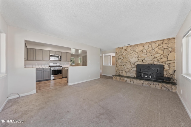 1513 S Riverview Dr, Gardnerville, NV 89460 - unfurnished living room featuring light colored carpet, healthy amount of natural light, and a textured ceiling