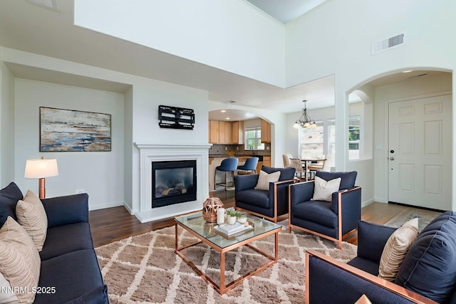 7680 Stone Bluff Way, Reno, NV 89523 - living area with arched walkways, wood finished floors, and a glass covered fireplace